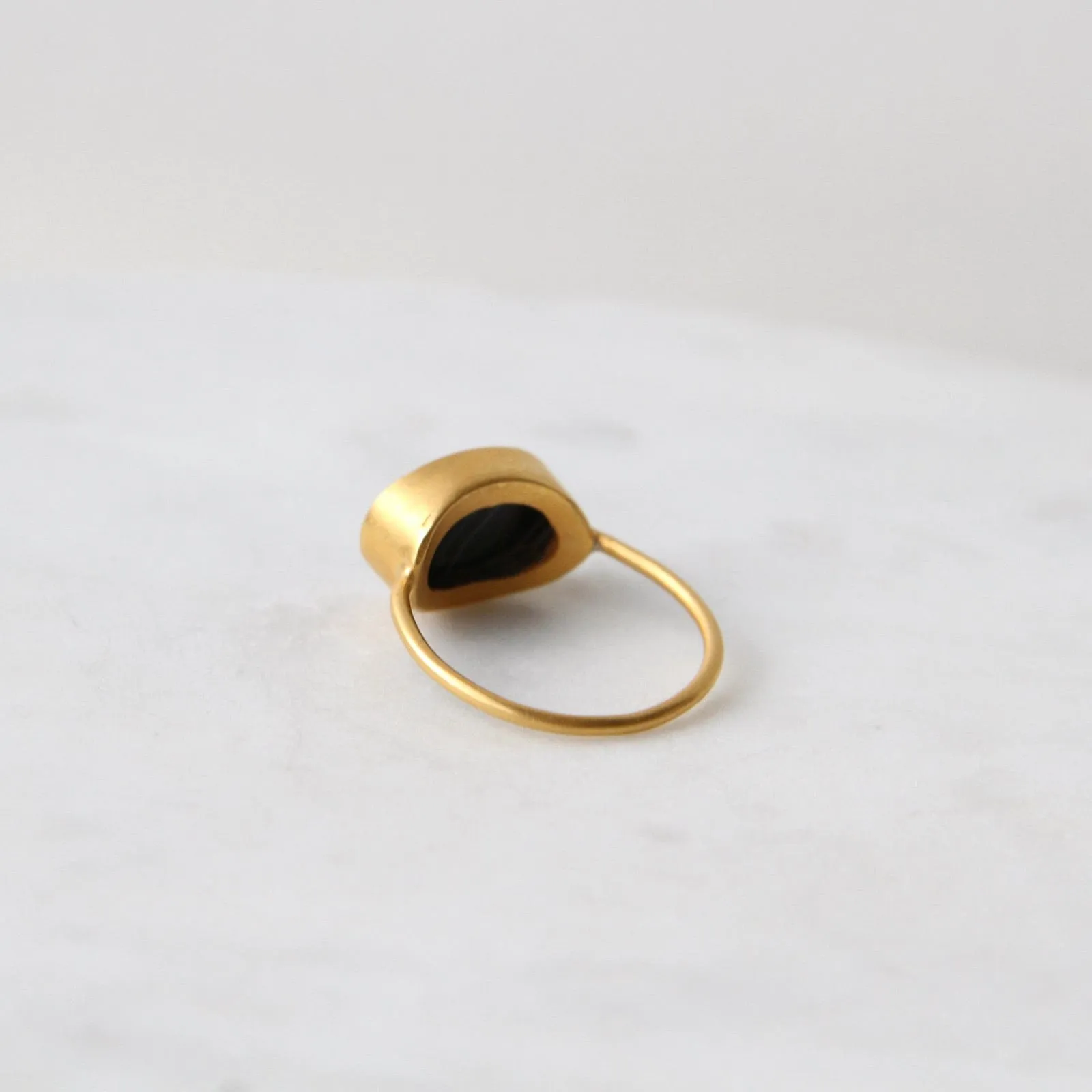 Oval Flat Cut Banded Black Onyx in Gold Plated Bra
